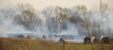 Hay bales burn in a field near State Highway 18 during the outbreak of wildfires in Lincoln County on March 14, 2025. An estimate of more than 10,000 acres burned in those fires, with well over a dozen hitting the area, according to Lincoln County Emergency Management. Wildfire season tends to run in the area from about November until things green up in the spring, though it depends on weather conditions year-to-year. Photo/Emily Kalka
