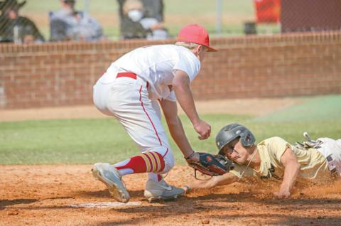 Dale’s Dayton Forsythe tags out a Fletcher runner during the regional tournament. Photo/Rick Hester