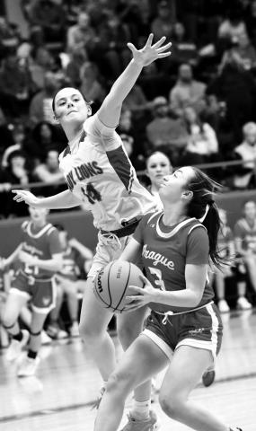 Prague’s Britten Himle (3) eyes a shot against the defense of Payslee Massengalee from Chandler during Prague’s 35-29 win last week. Photo/Brian Blansett