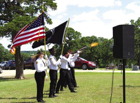 The color guard from American Legion Post #64 in Chandler carry out a rifle salute during the Memorial Day ceremony at Oak Park Cemetery in Chandler. The Post organizes the ceremony every year on Memorial Day for the community. Photo/Emily Kalka