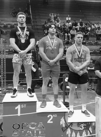 Ronan Martin of Prague (middle) receives a medal after winning state runner-up at the OCPA State Powerlifting Championship in the 181-pound class. Photo/James Martin