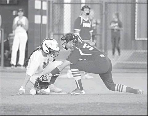 Prague second baseman Diana Manning reaches for the ball as Meeker’s Madison Buoy comes in safely in their game Thursday. Photo/Brian Blansett