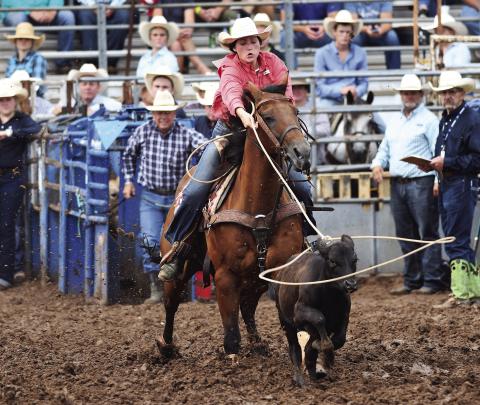 Chandler roper Rylee Moore drops a loop on her calf during break-away roping Monday at the International Finals Rodeo in Shawnee. For more on the rodeo and competitors from Central Oklahoma. Photo/Brian Blansett