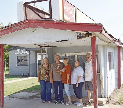Agra alumni Sue Chesnut, Gary Roberts, Nancy Roberts, Linda (Hart) Palkowski and Ted Evans are just a few members of the Agra Alumni Association working to save Dale’s concession stand. They are currently raising money to fix up the stand and honor the man who ran it, Dale McFarlin. Photo/Emily Kalka