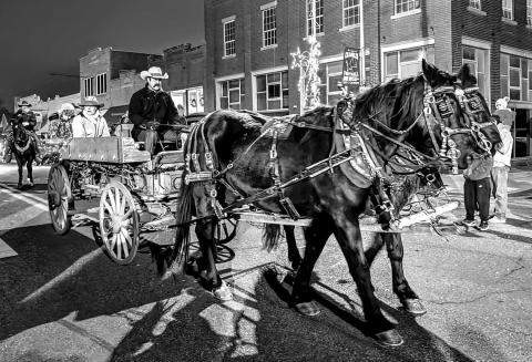 Members of the Cowboy United Church take a horse-drawn wagon down the street during the Christmas parade on Dec. 6 in Chandler. This year’s theme was Christmas on the Range, with many floats embracing it. Photo/Jennifer Pryor