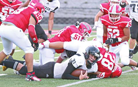 Meeker’s Bobby Brooks hold on to a fumble recovery in the middle of lots of red jerseys. Photo/Traci Cook