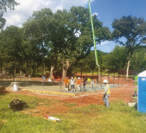 Workers begin pouring the pad at the new basketball court at Reed Park. Work to renovate the area is underway, and the plans include a new pavilion and parking as well as the court. Photo/Marvin Holmes