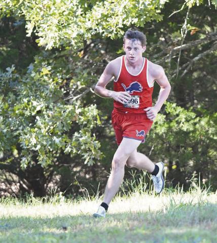 Junior Rhett Haley rounds a curve at Stroud during the Lions’ first cross country meet of the year. He ran 10:37.3 to finish seventh and lead the Chandler boys. Photo/Brian Blansett