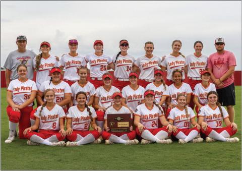 Above, Dale’s Lady Pirates pose with their regional championship trophy. Photo/Rick Hester. Below left, Peyton Davis rounds third in Stroud’s game against Prague last week prior to the regional tournaments. Below right, Prague’s Liyah Daumann awaits a pitch against Stroud.. Photos/Mario Holland