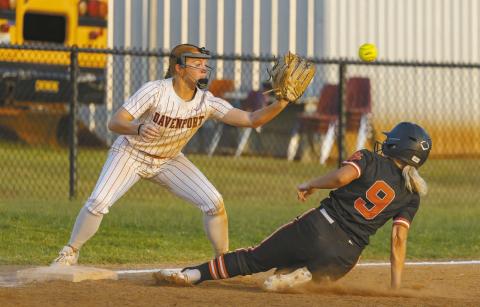 Carney’s Braycelee Holmes slides safely into third base, beating the tag by Autumn Gaylord of Davenport in action last week. Photo/Rick Hester