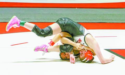 In the top and bottom-left photos, Remy Whitney from McLoud battles Kylee Tran from Tulsa Union High School in the finals match for the 100-lbs weight class at the SuperGirl 64 Tournament at Union. In the bottom-right photo, Lizzy Pryor from Chandler holds Abi Lavender from Searcy High School in Arkansas in a split. Photos/Jennifer Pryor