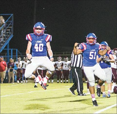 Daven Williams (40) celebrates along with Traydon Richardson during the Lions’ win over Kellyville Friday. They’re See Page 2B back on the road this week, heading down Highway 18 for a match with the Meeker Bulldogs. Photo/Jessica Pollard